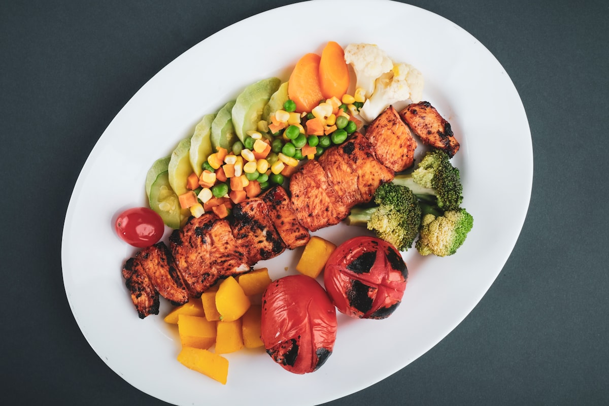 Quinoa grain bowl with roasted vegetables, nuts, and tahini dressing